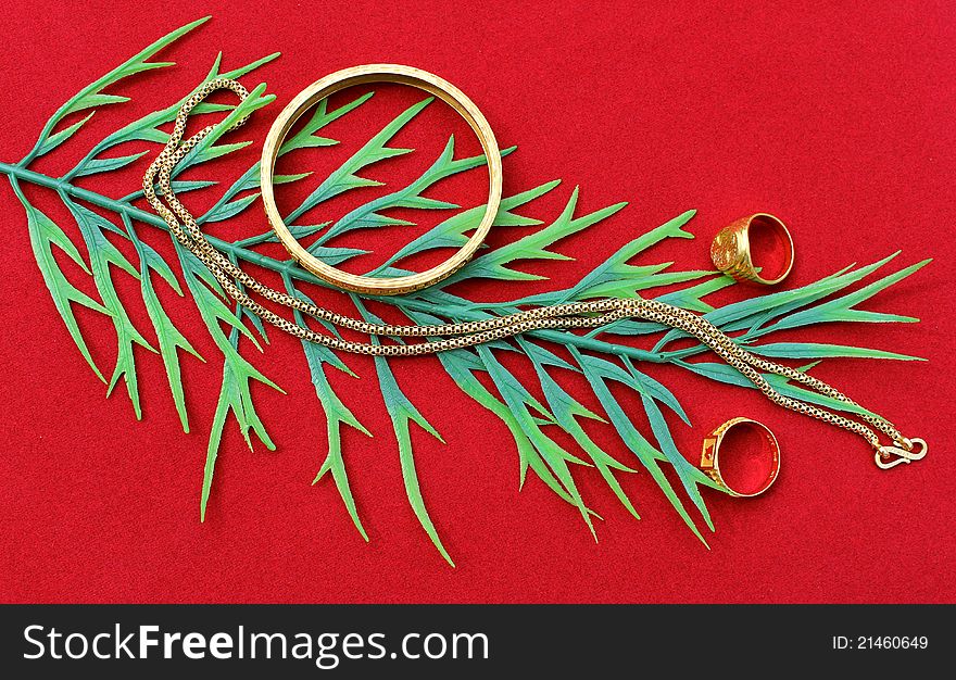 Glitteing gold ornaments displayed on red background