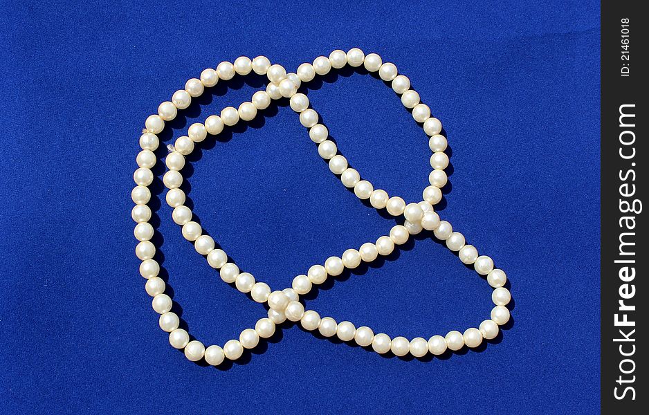 White pearl chains on blue background