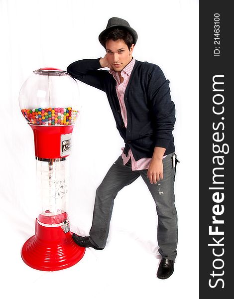 Man leaning on gumball machine against white background. Man leaning on gumball machine against white background.
