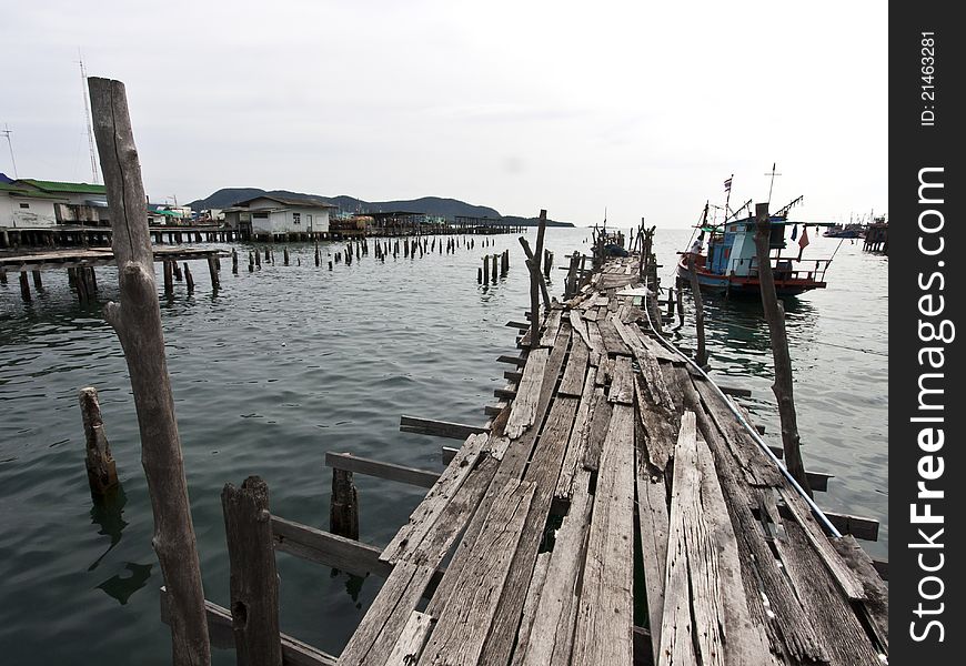 Old wooden fishing bridge to the sea