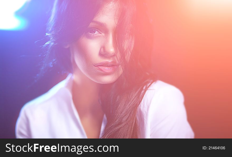 Studio portrait of attractive young woman on dark background