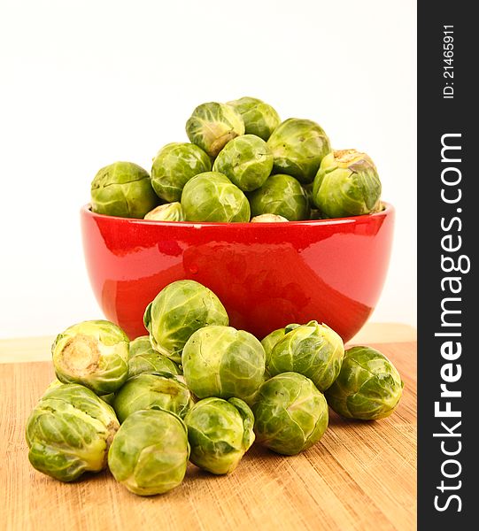 Fresh Brussels sprouts in a bowl. Close up on white background