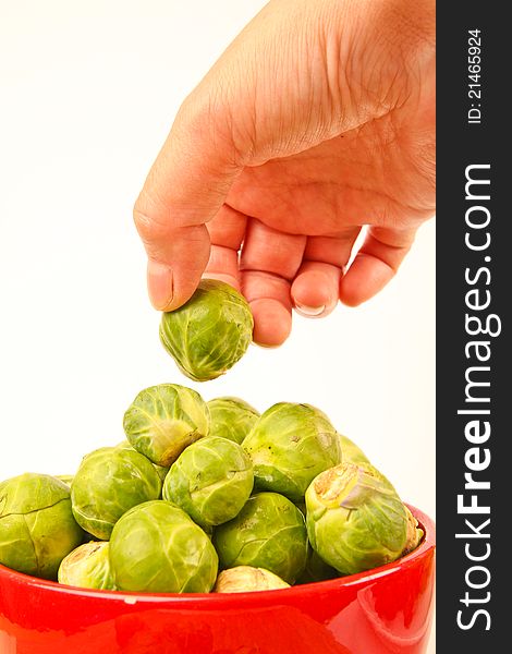 Fresh Brussels sprouts in a bowl. Close up on white background