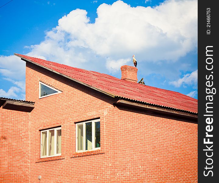 Stork sitting on the top of a roof. Stork sitting on the top of a roof