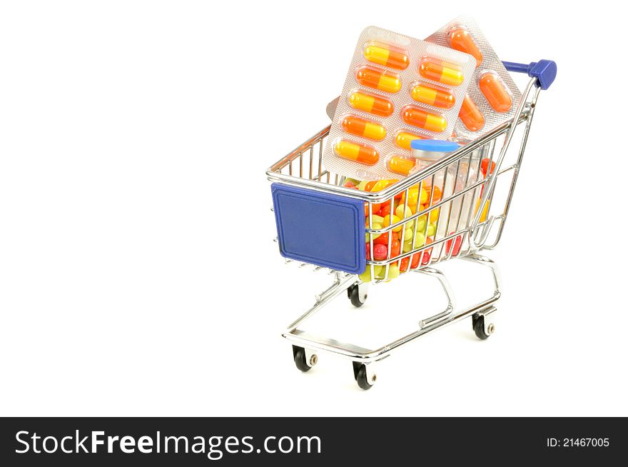 Shopping cart with medecine pills on a white background. Shopping cart with medecine pills on a white background