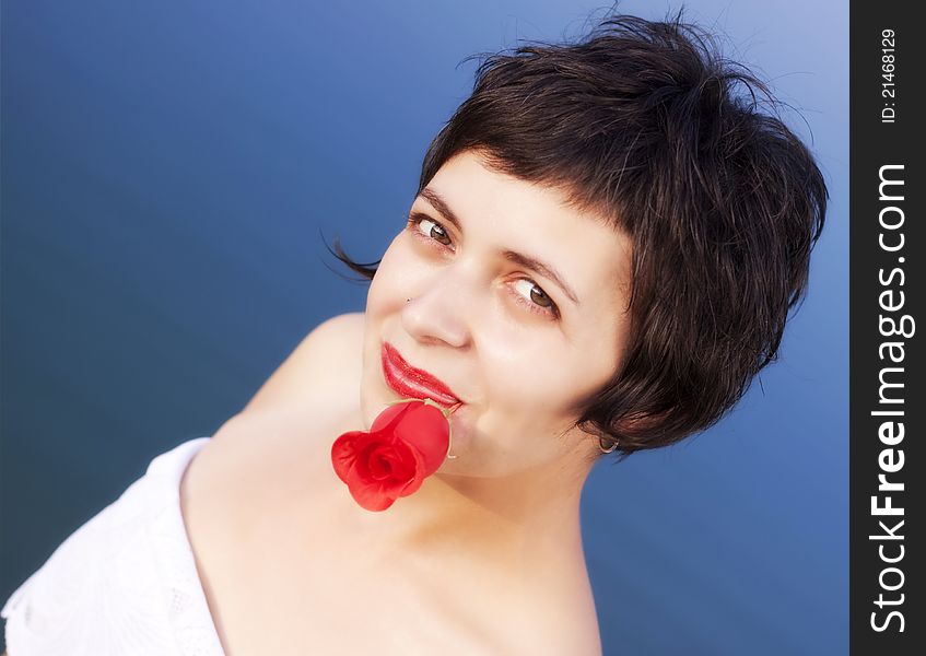 Portrait beautiful young woman with red rose in the water