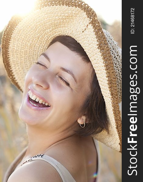 Portrait of beautiful brunette woman in summer reed