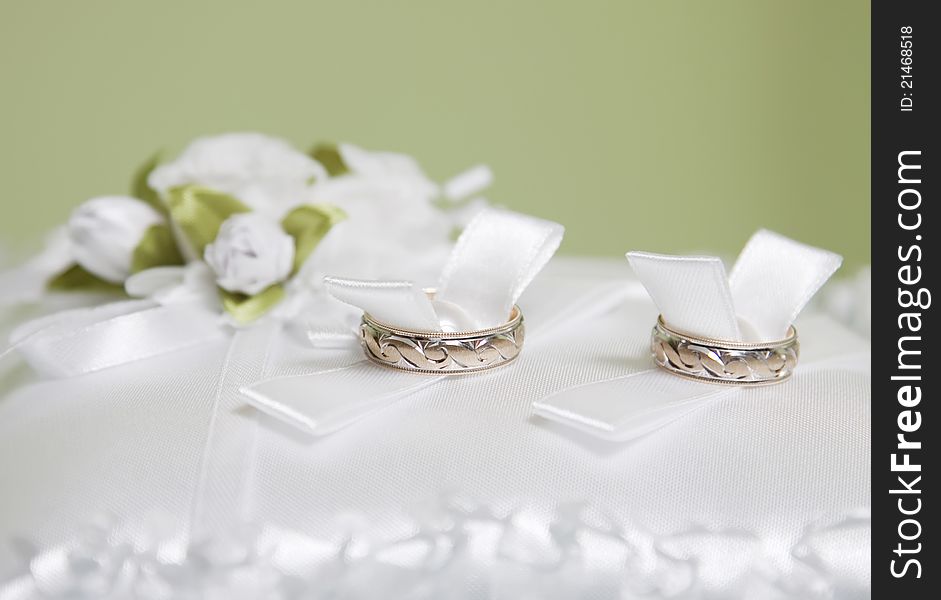 Wedding rings on white pillow