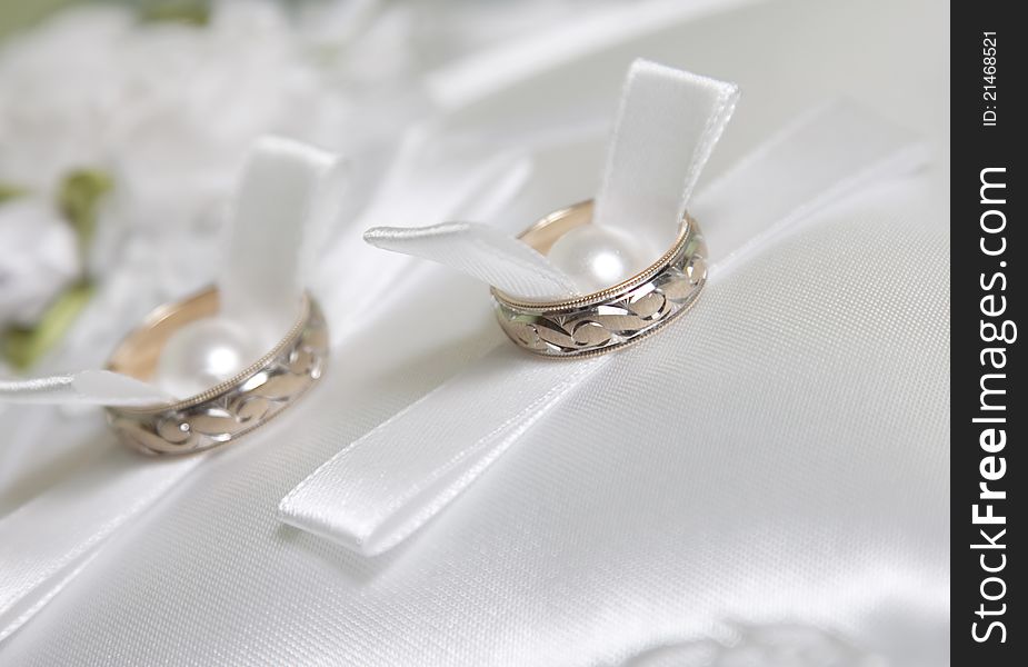 Wedding rings on white pillow