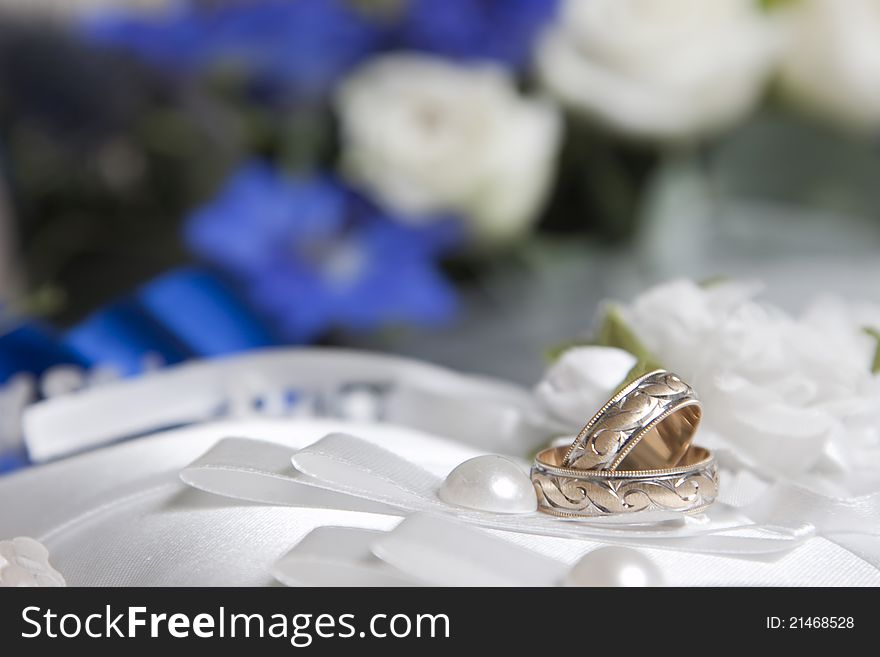 Wedding rings on white pillow