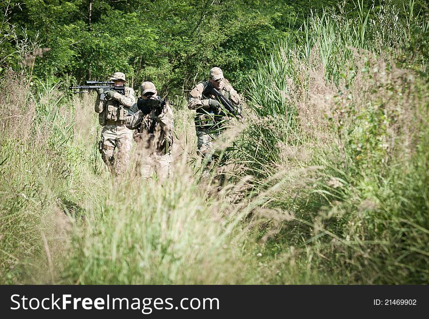 Rebel soldiers during patrol on battle field, aiming on enemy. Rebel soldiers during patrol on battle field, aiming on enemy