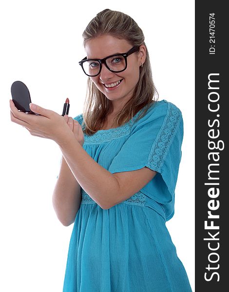 Happy woman applying lipstick and holding a compact