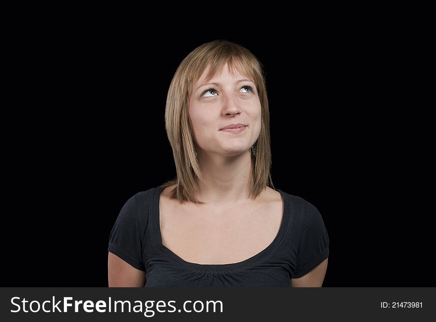 Beautiful thoughtful girl isolated on black background