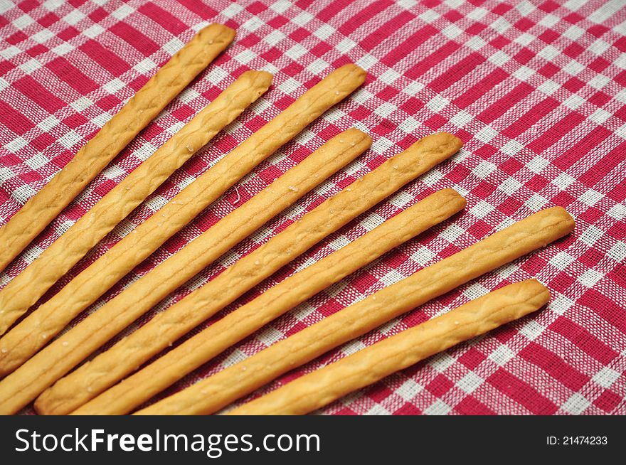 Salty breadsticks over red and white cloth