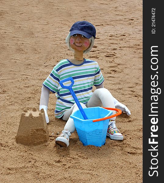 A Scarecrow Figure of a Youngster Playing in the Sand. A Scarecrow Figure of a Youngster Playing in the Sand.