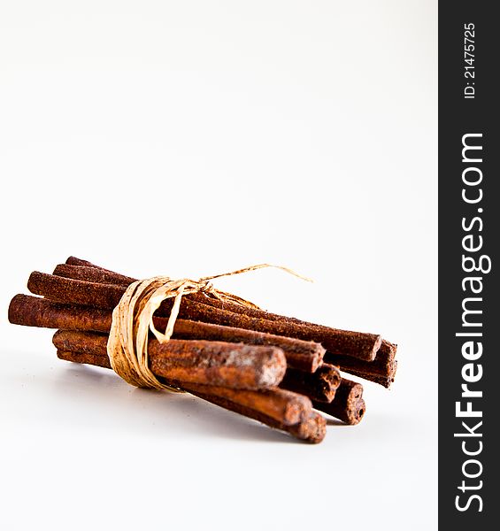 Rustic brown cinnamon sticks bundled together with raffia