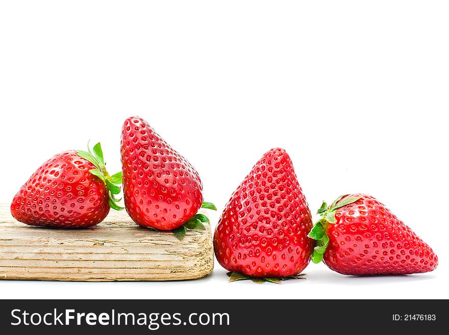 Group of strawberries over a piece of old wood. Group of strawberries over a piece of old wood