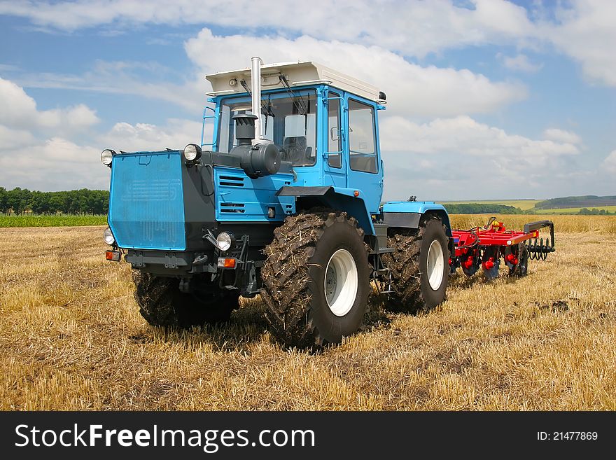Big powerful traktoror on the field