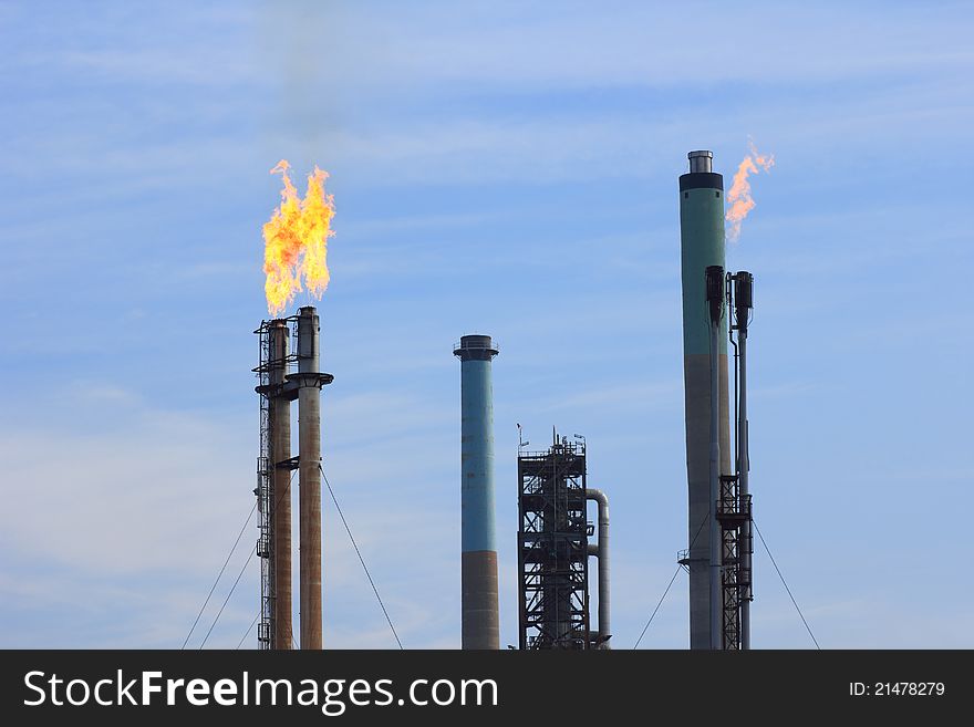 Industrial chimneys of a refinery with flames coming out. Industrial chimneys of a refinery with flames coming out