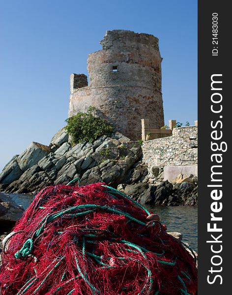 Fishing net on the mole under an ancient tower