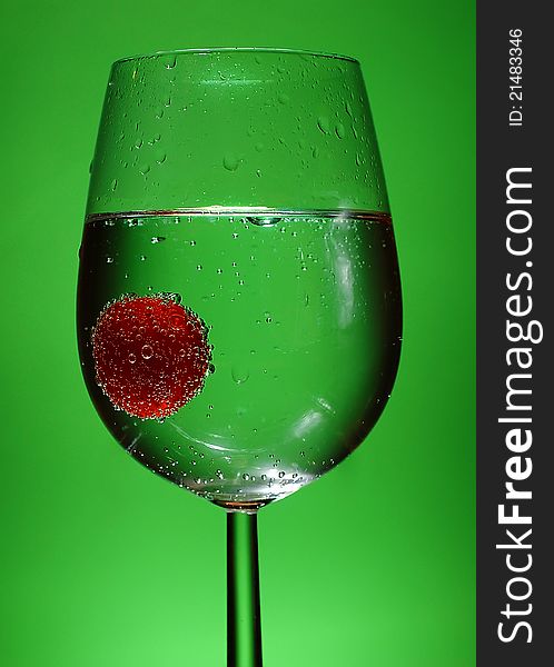 Tomatoe diving in a glass of sparkling water. Tomatoe diving in a glass of sparkling water