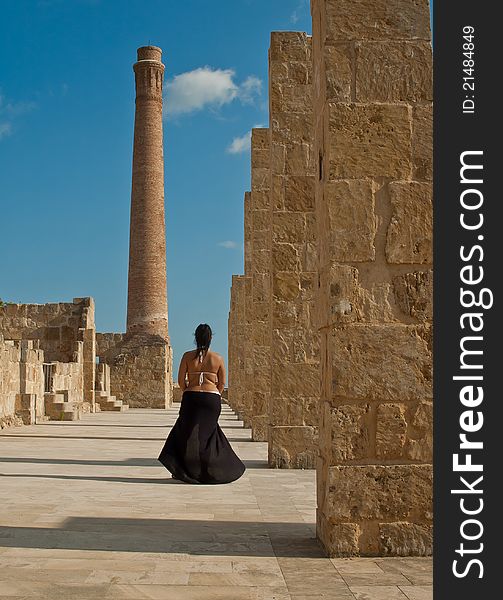 Walking woman on tuna fishing ruins in natural oasis of vendicari during sunset. Walking woman on tuna fishing ruins in natural oasis of vendicari during sunset