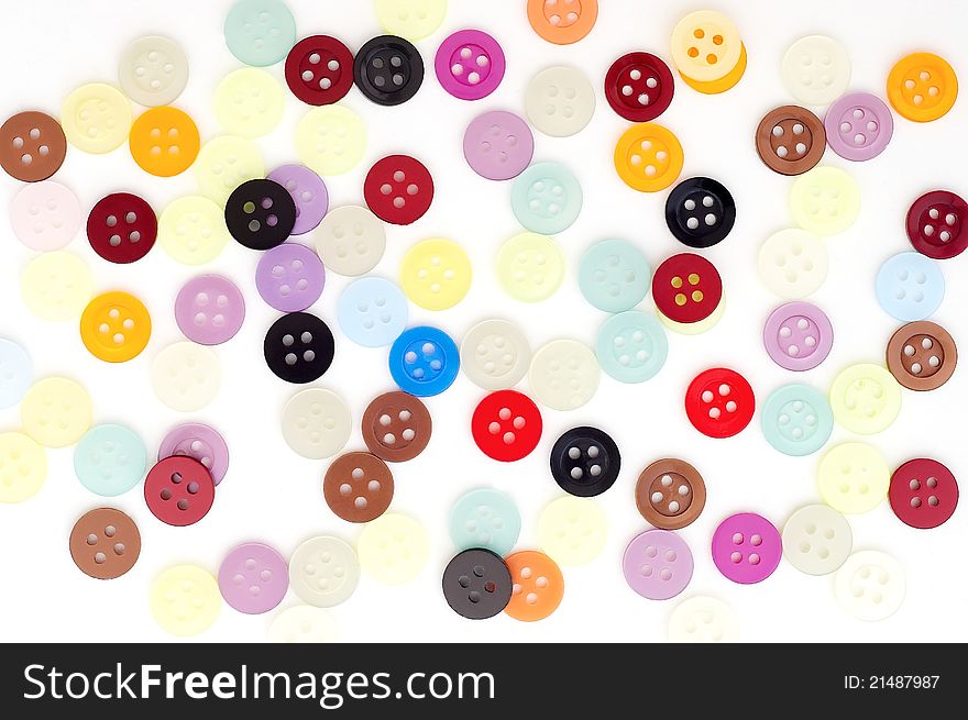 Coloured buttons on white ground.