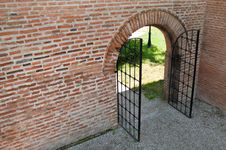 Opened Iron Forged Gate With Brick Wall Stock Photography