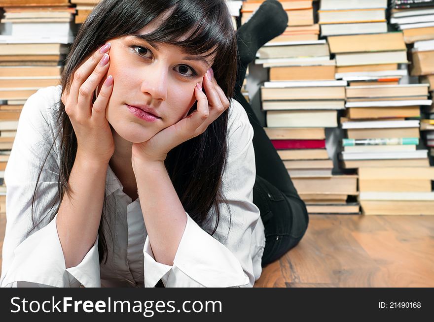 Young student girl on the floor looks bored