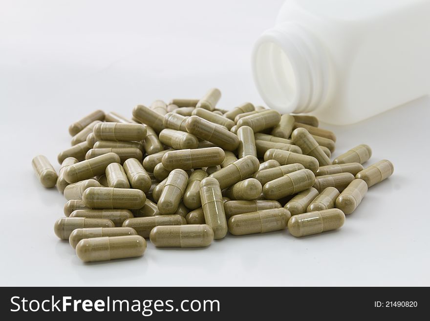 Herbal medicine capsule on white background