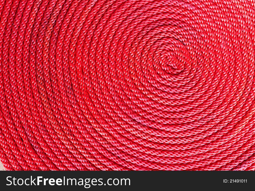 Spiral coil of braided red rope. Spiral coil of braided red rope
