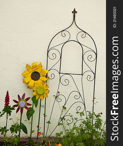 White wall with metal flowers and trellis. White wall with metal flowers and trellis.