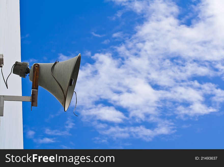 Old loudspeaker against cloudy blue sky. Old loudspeaker against cloudy blue sky