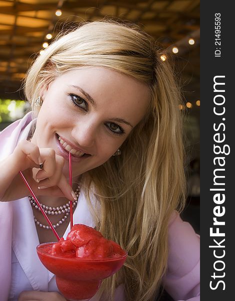 Gorgeous blonde girl enjoying strawberry cocktail. Gorgeous blonde girl enjoying strawberry cocktail