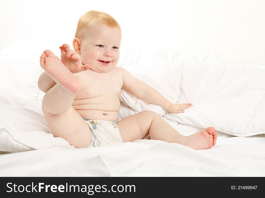 Happy child in a white bed. Happy child in a white bed