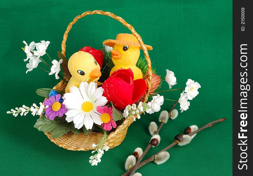 Easter basket with duckling on green