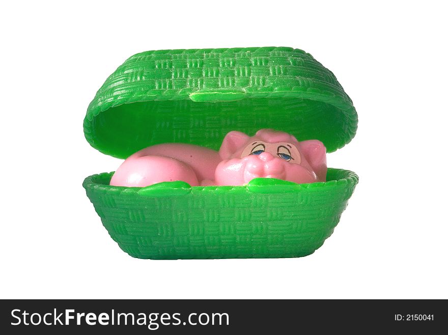 Pink toy cat sleeping in a green carriage