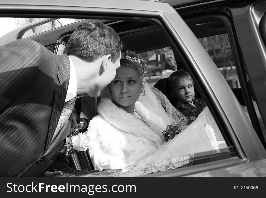 The bride with the little boy in the machine and seeing off groom. b/w. The bride with the little boy in the machine and seeing off groom. b/w