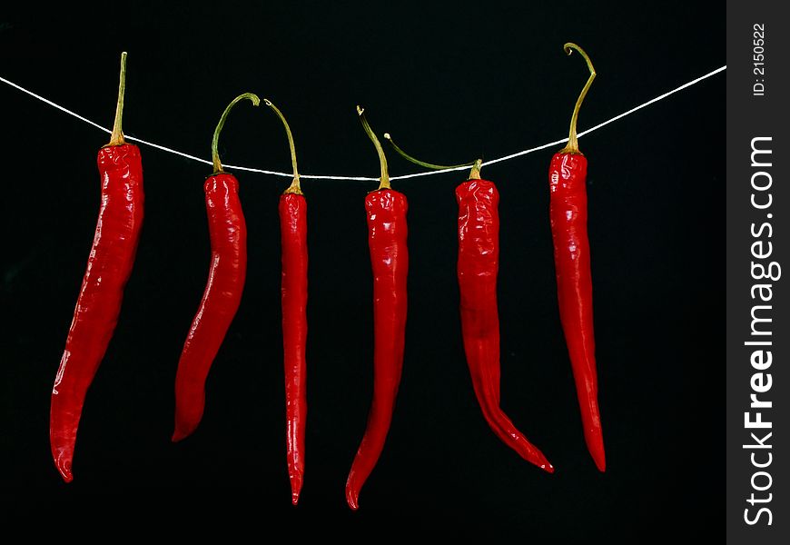 Red hot peppers isolated on black background. Red hot peppers isolated on black background