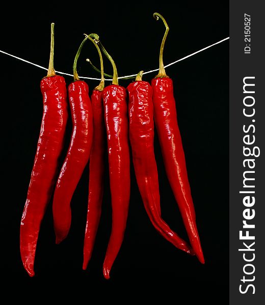 Red hot peppers isolated on black background. Red hot peppers isolated on black background