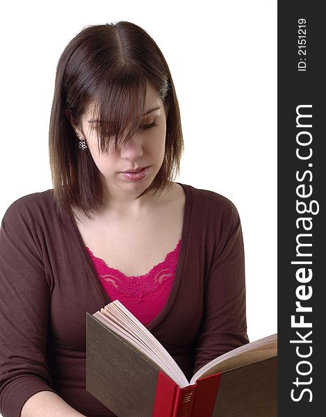 Young woman reading a hardcover book.