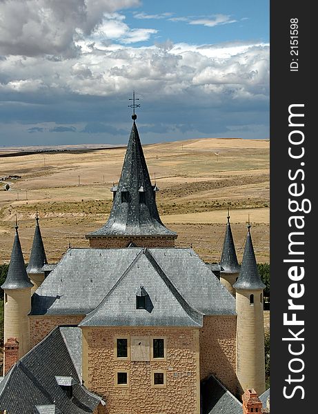 Peaky roof with sundial and cloudy sky. Peaky roof with sundial and cloudy sky