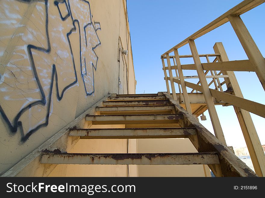 Graffiti and old steel abandoned urban stairs