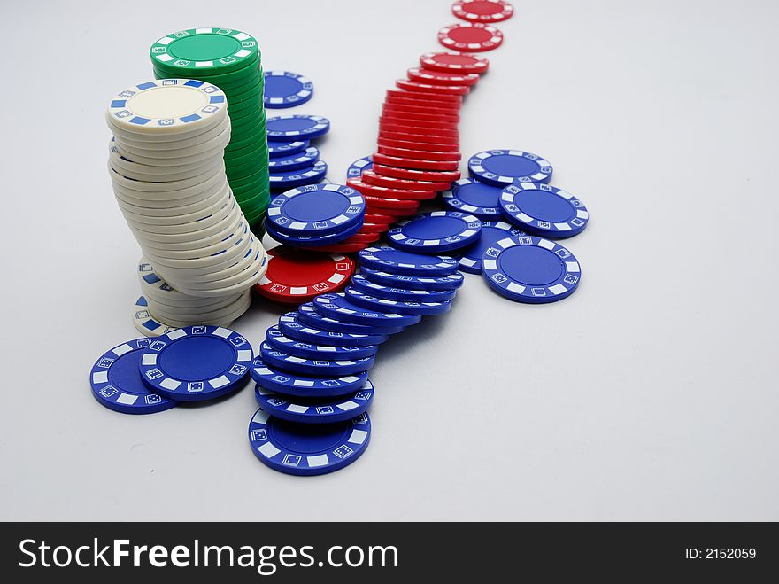 A background of scattered poker chips in white background