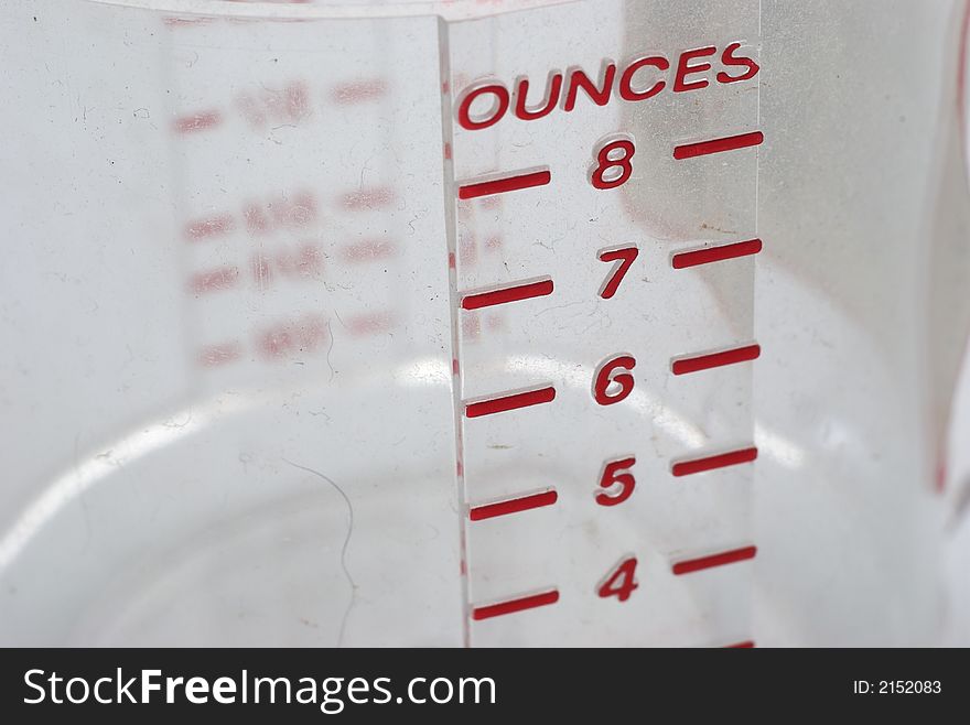 A close up of a measuring cup with ounce measurement. A close up of a measuring cup with ounce measurement