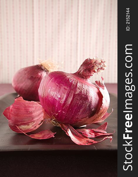 Arrangement of Red Onions on a wooden cutting board