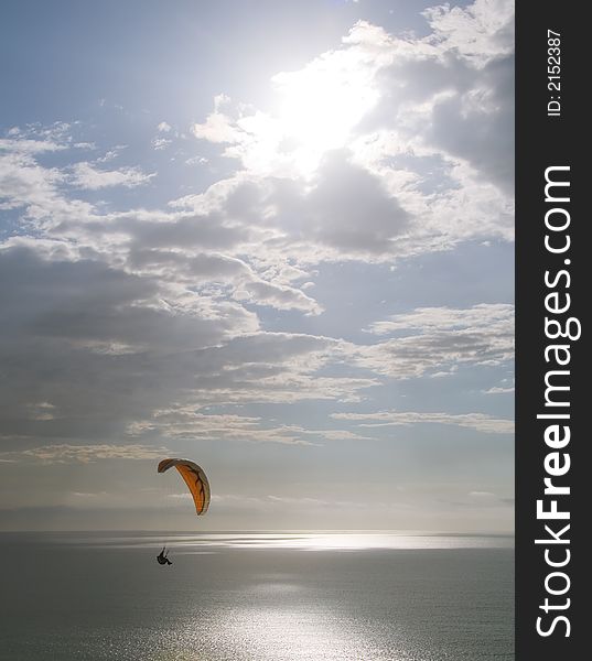 A paraglider soaring over the Pacific Ocean. A paraglider soaring over the Pacific Ocean