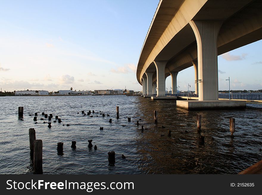 Tall bridge over fishing dock recreation area on the river. Tall bridge over fishing dock recreation area on the river.