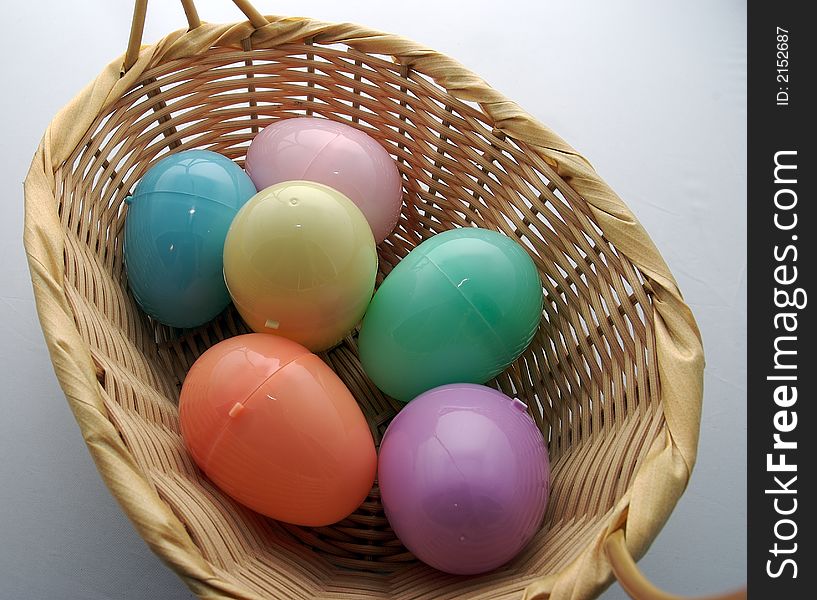 Multi-colored easter eggs in a basket. Multi-colored easter eggs in a basket