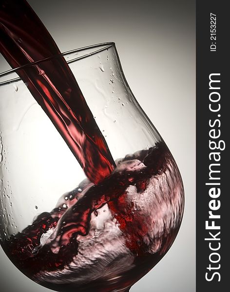 Red wine splashing in glass. Red wine splashing in glass